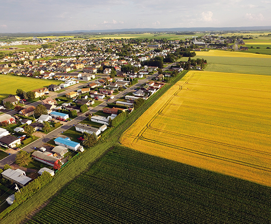 Aerial view rural town bordered by fields
