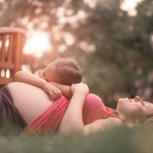 54847024 - pregnant mother and daughter expecting newborn brother