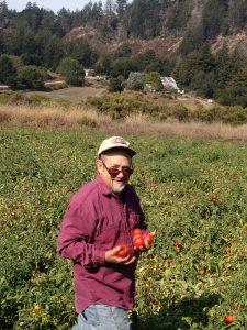 Mark Lipson, HHRA's policy director, holding part of an organic tomato harvest from 2018